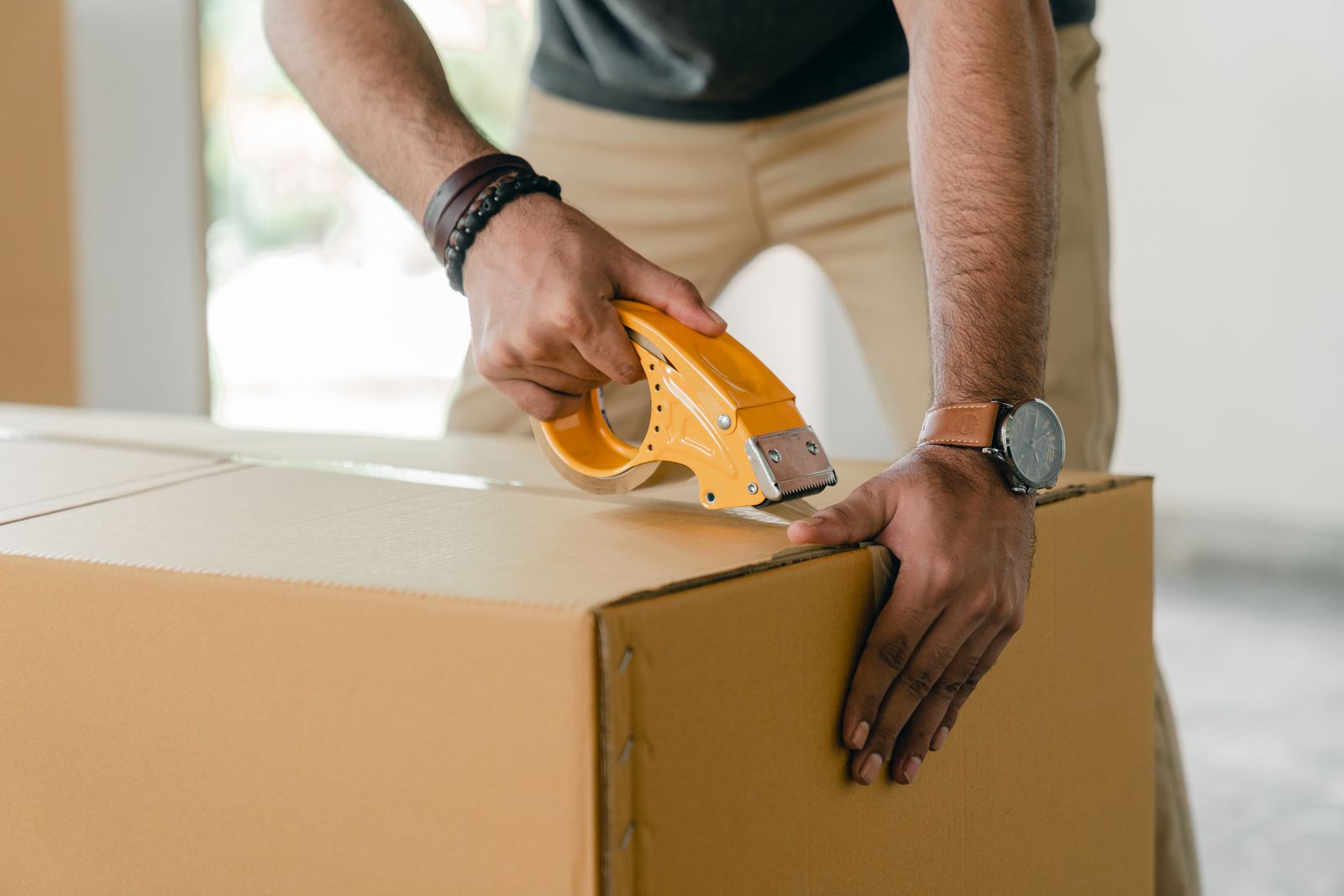 Delivery professional carrying a parcel beside a van
